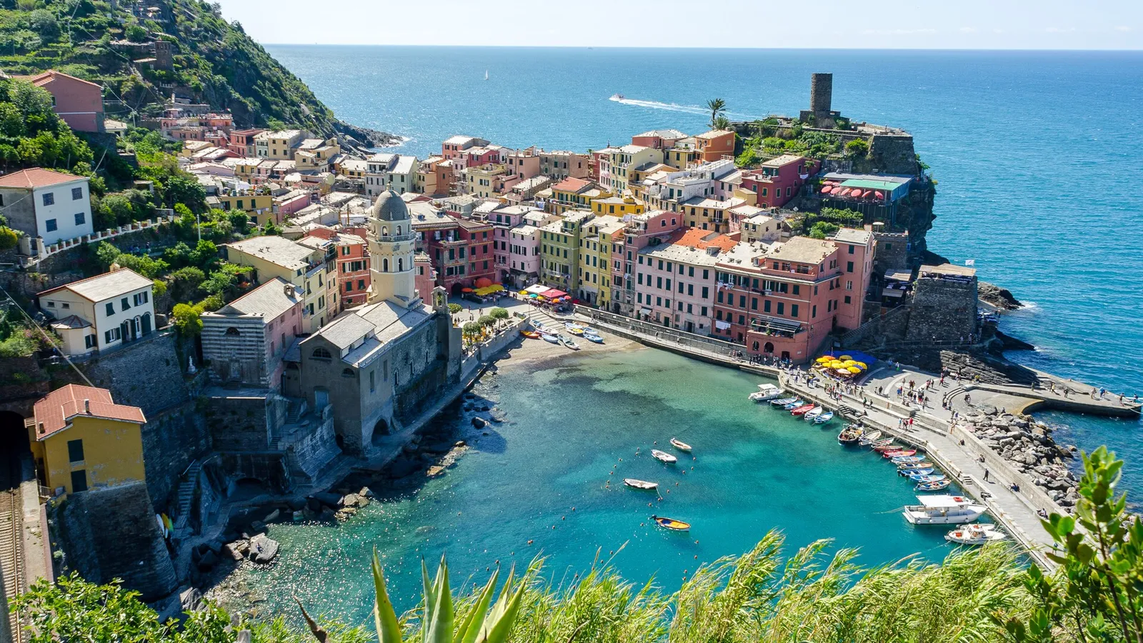 The colourful houses and harbour of Vernazza village on a sunny day in Cinque Terre, Italy