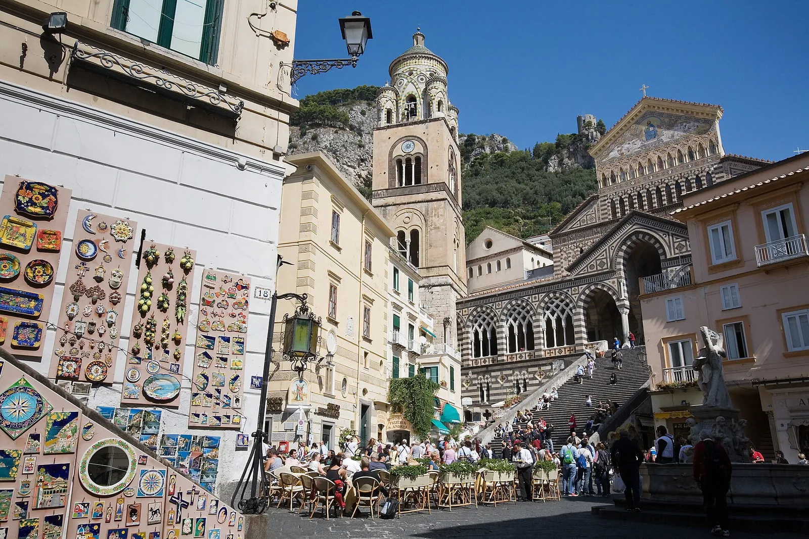 Cafes and the striped cathedral on the main square of Amalfi town on the Amalfi Coast, Italy