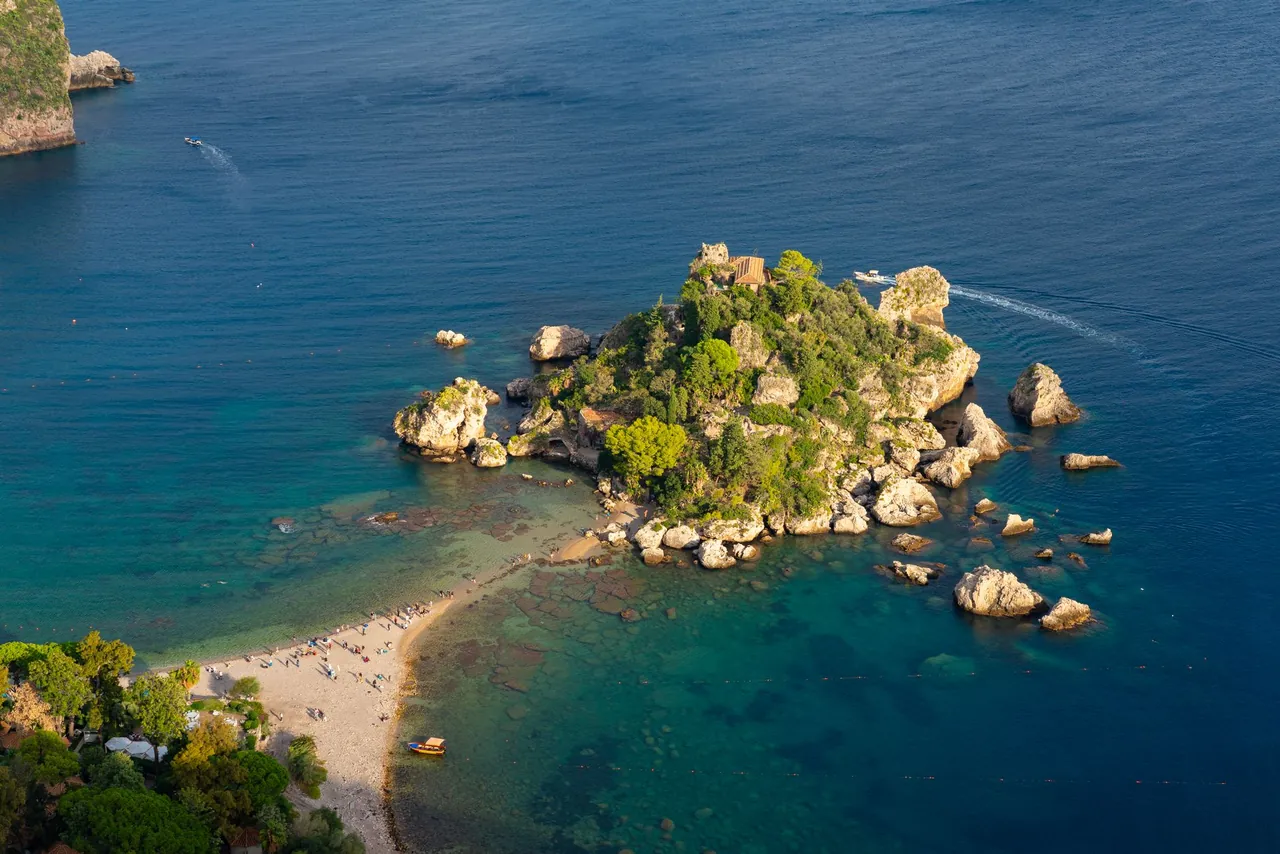 Isola Bella island and pebble beach below Taormina in Sicily Italy