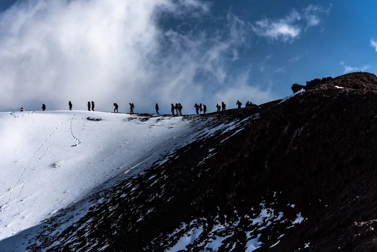 Snow-capped crater and slopes of Mount Etna volcano in Sicily Italy
