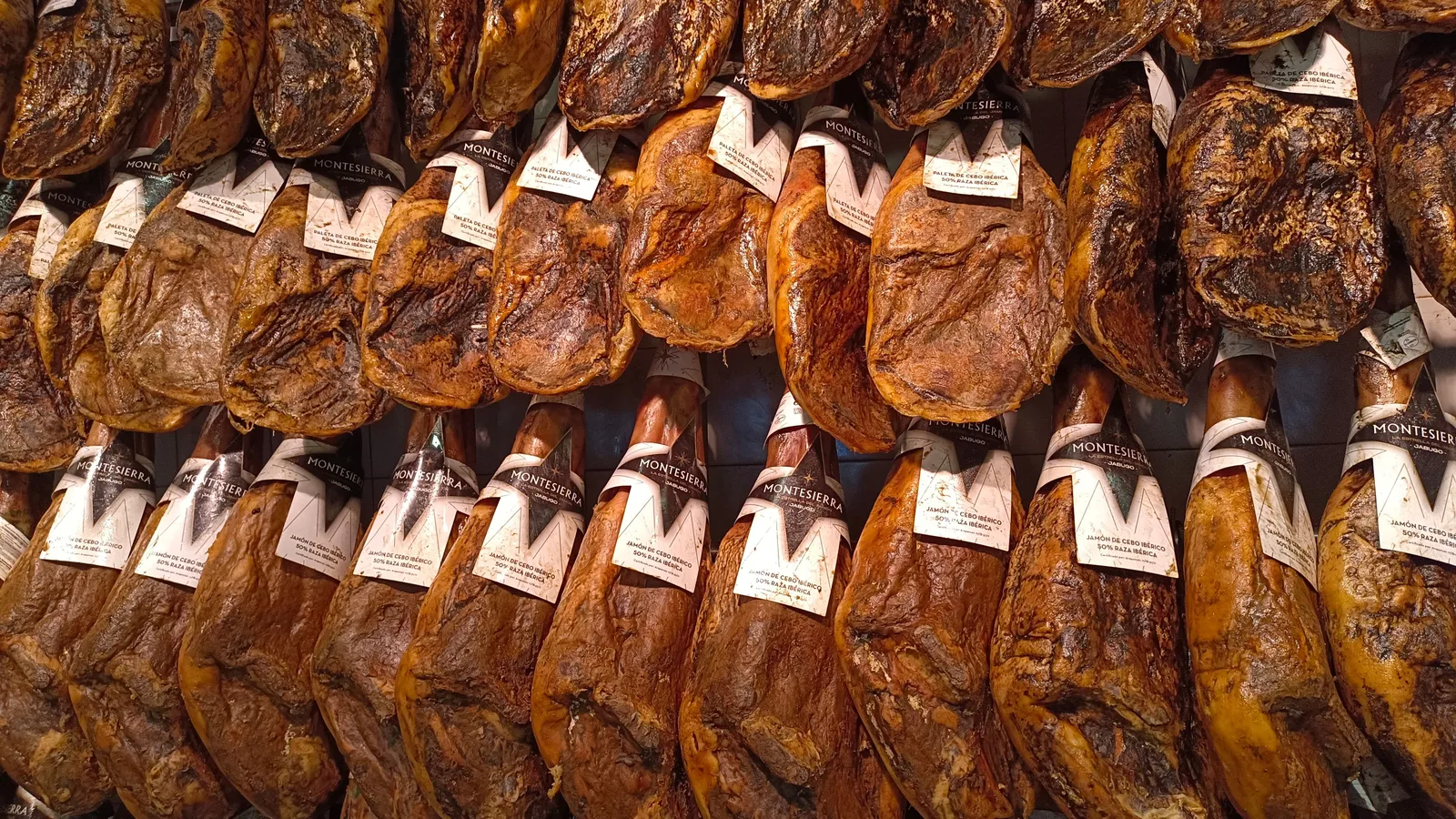 Legs of Parma ham hanging in a curing room in Emilia-Romagna, Italy