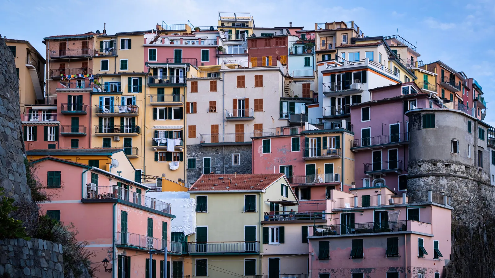 Pastel houses stacked up the hillside in a Cinque Terre village, Liguria, Italy
