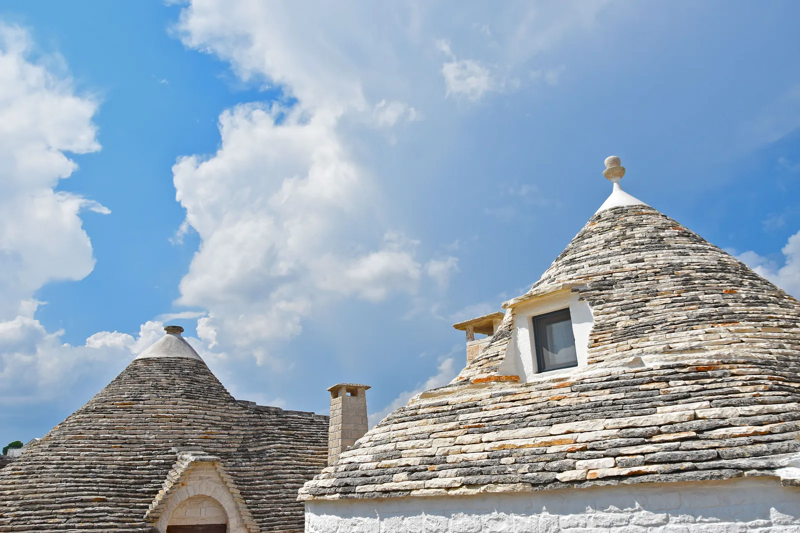 Traditional white trulli houses with conical stone roofs in Alberobello, Puglia