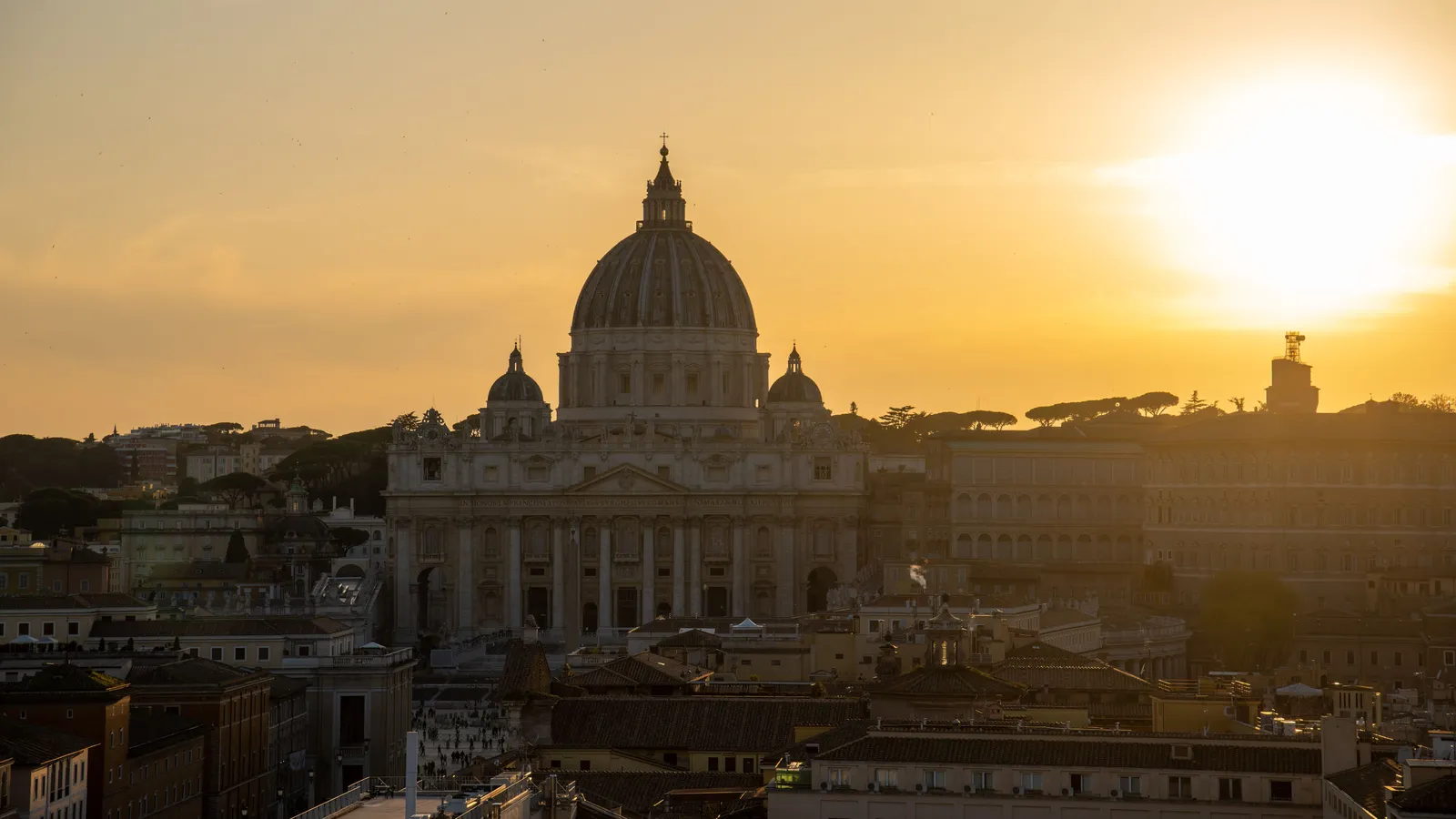 Warm evening light over terracotta rooftops and a domed skyline in a historic Italian city
