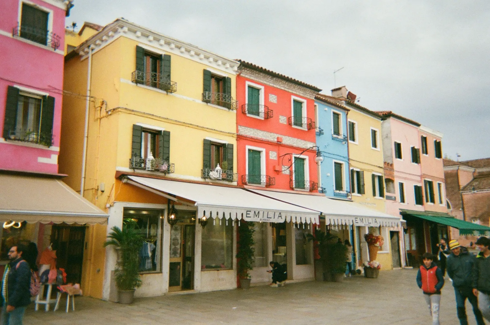 Brightly painted houses along a street on Burano in the Venetian lagoon, Italy