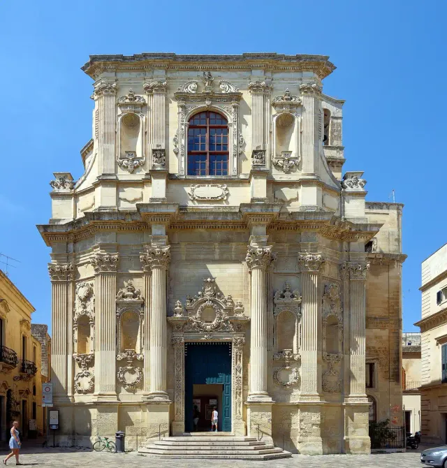 An ornate baroque facade in pale sandstone with statues in niches