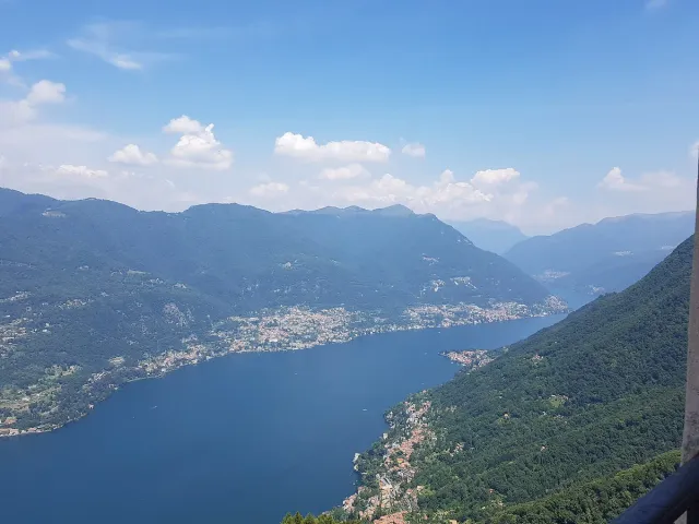 A high view over a narrow lake between mountain ridges on a clear day