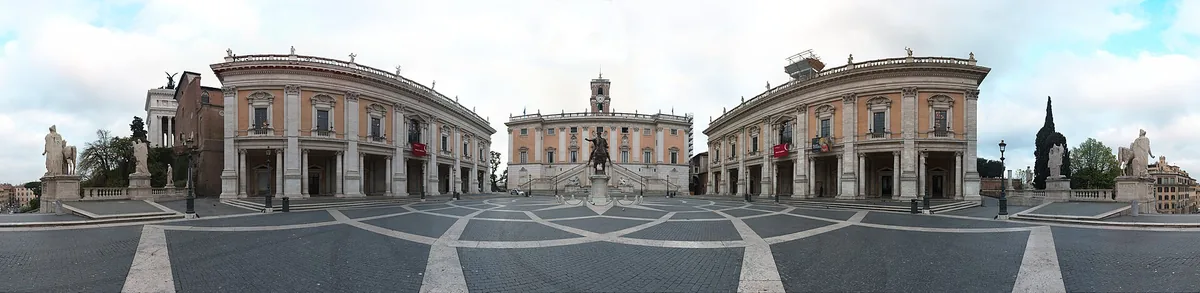 Symmetrical square with star patterned paving, an equestrian statue at the centre and palaces on both sides
