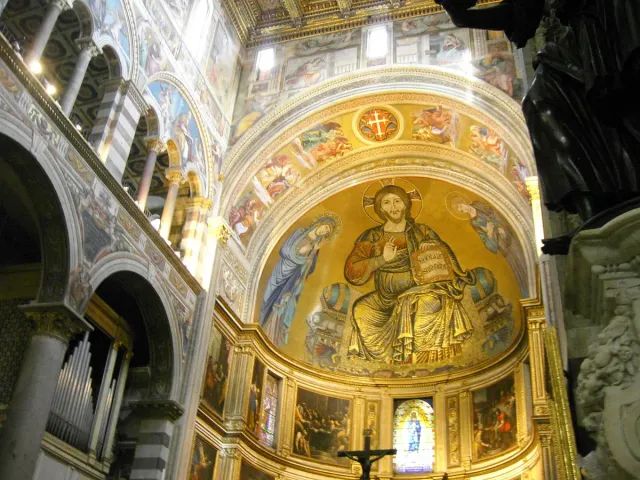 A gilded apse vault with a giant mosaic figure above the nave
