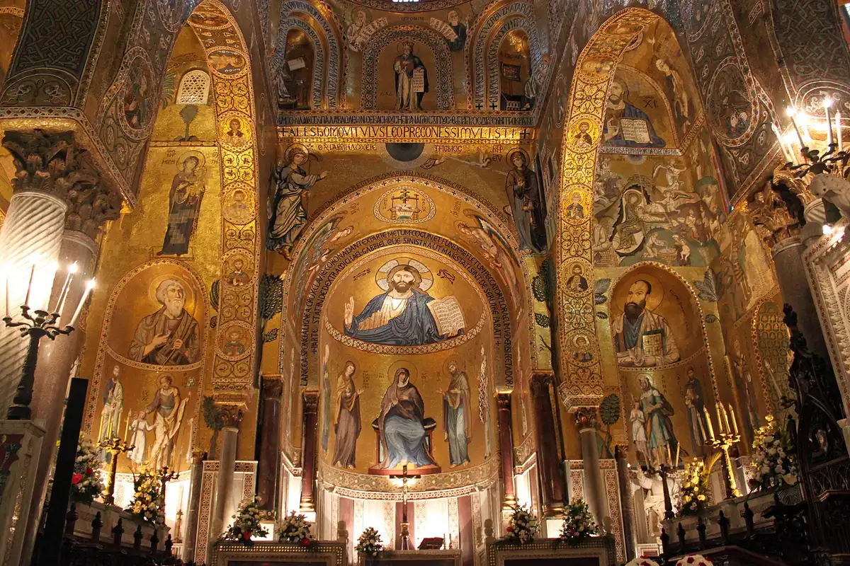 Byzantine gold mosaics on arches and an apse dome in a lit prayer hall