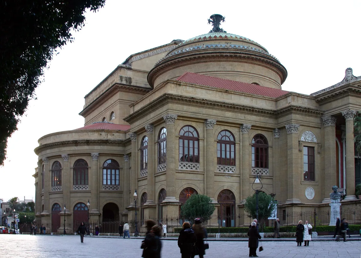Monumental sandstone opera house with a dome, arched windows and a square in front