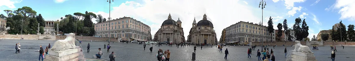 Wide paved square with two domed twin churches flanking a central street