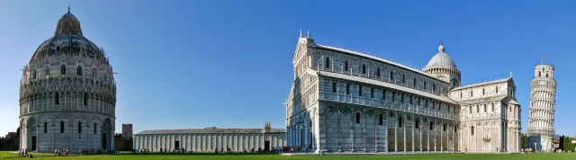 A striped marble cathedral with arcaded galleries on a green lawn