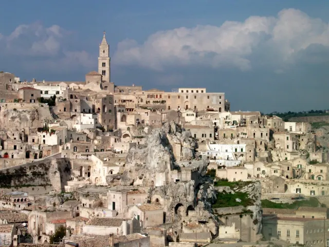 A dense stone city of cave houses on a canyon slope