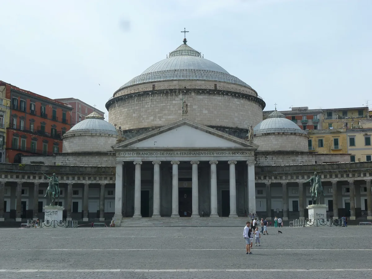 Domed church with a curved colonnade wrapping a wide empty square