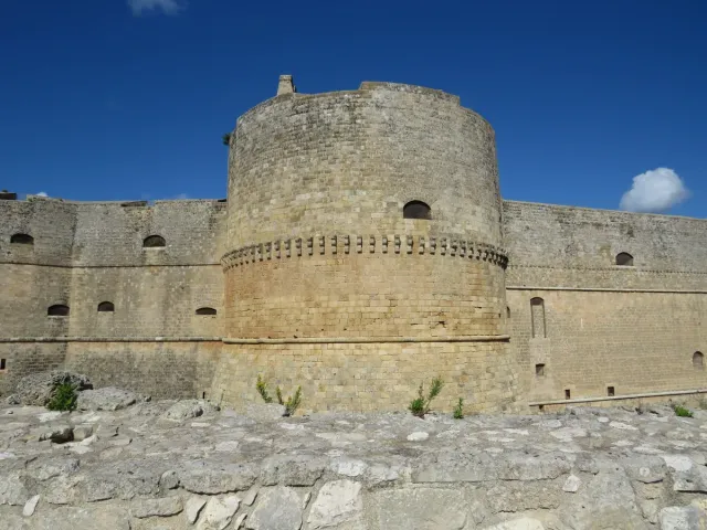 A round pale stone fortress tower with thick walls