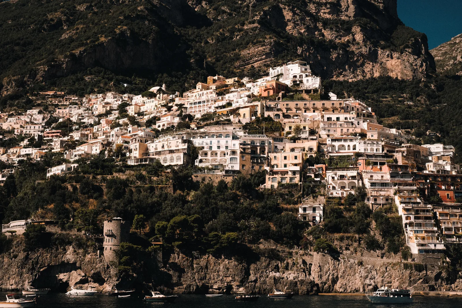 Pastel houses stacked down the cliff to the sea at Positano on the Amalfi Coast, Italy