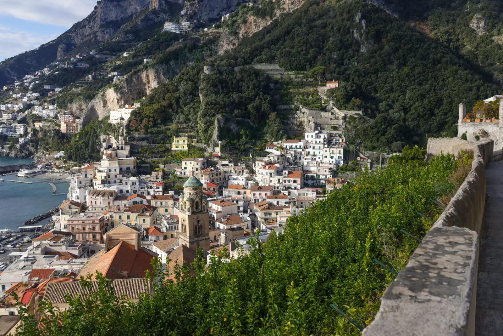 The town of Amalfi and its harbour seen from the cliff road, Italy