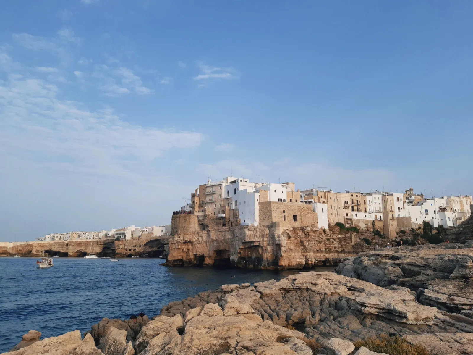 The whitewashed clifftop town of Polignano a Mare above its cove beach