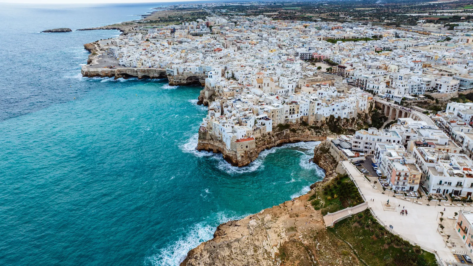 White houses on a cliff above turquoise sea at Polignano a Mare in Puglia, Italy