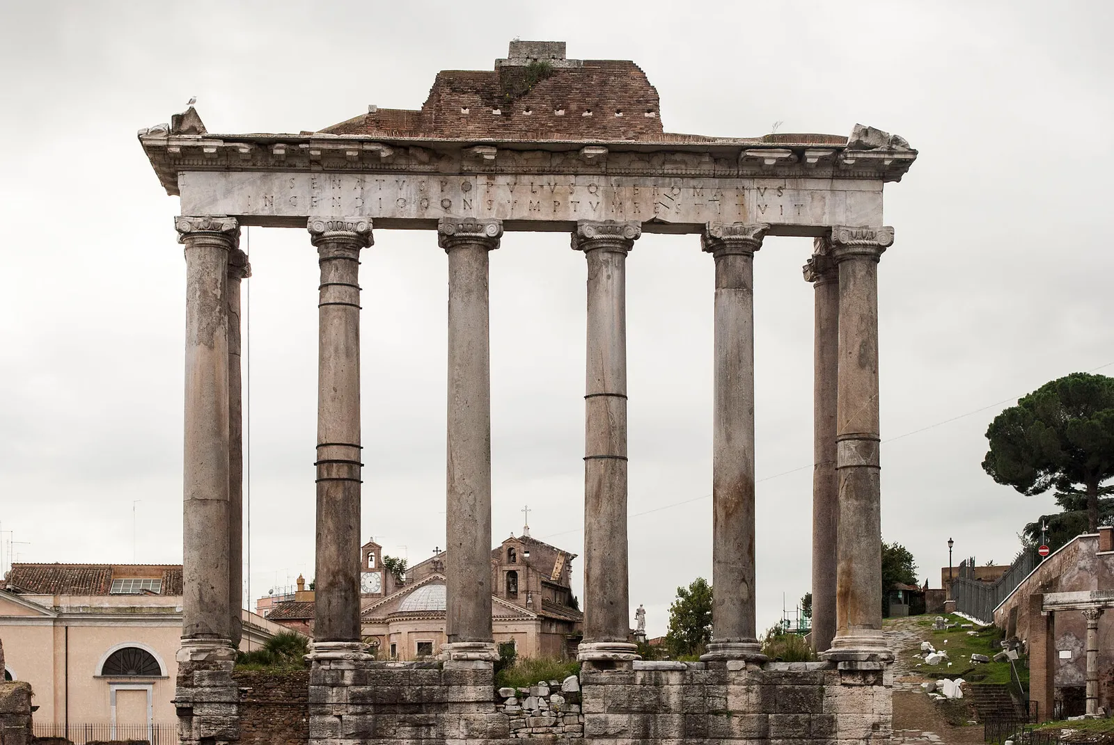 The columns of the Temple of Saturn rising above the Roman Forum in Rome, Italy