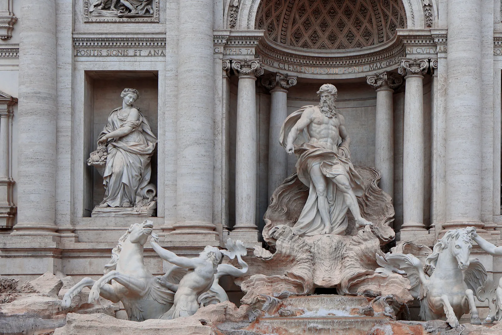 Carved figures and falling water at the Trevi Fountain in Rome, Italy