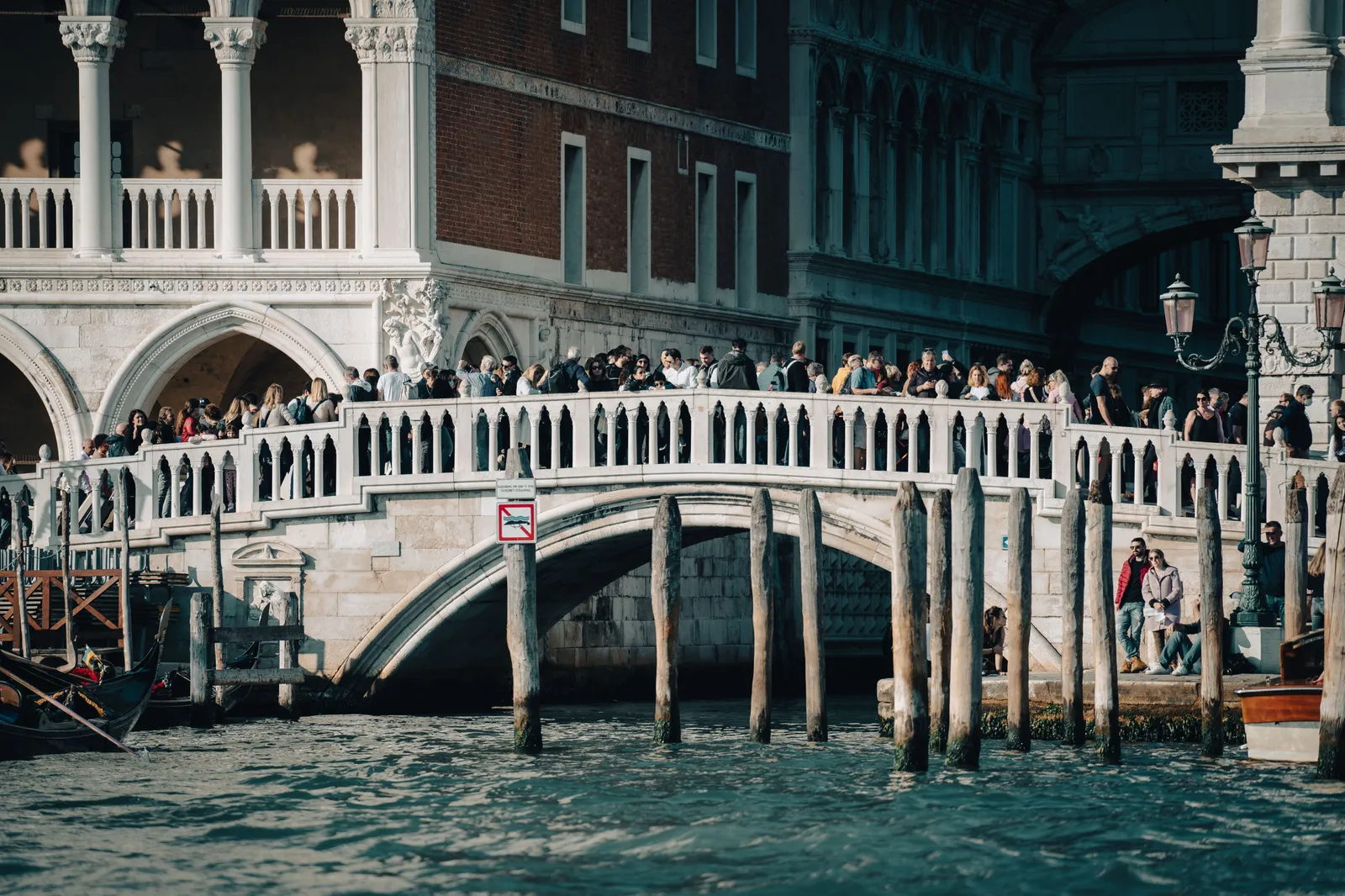 A crowded bridge over a canal in Venice, Italy