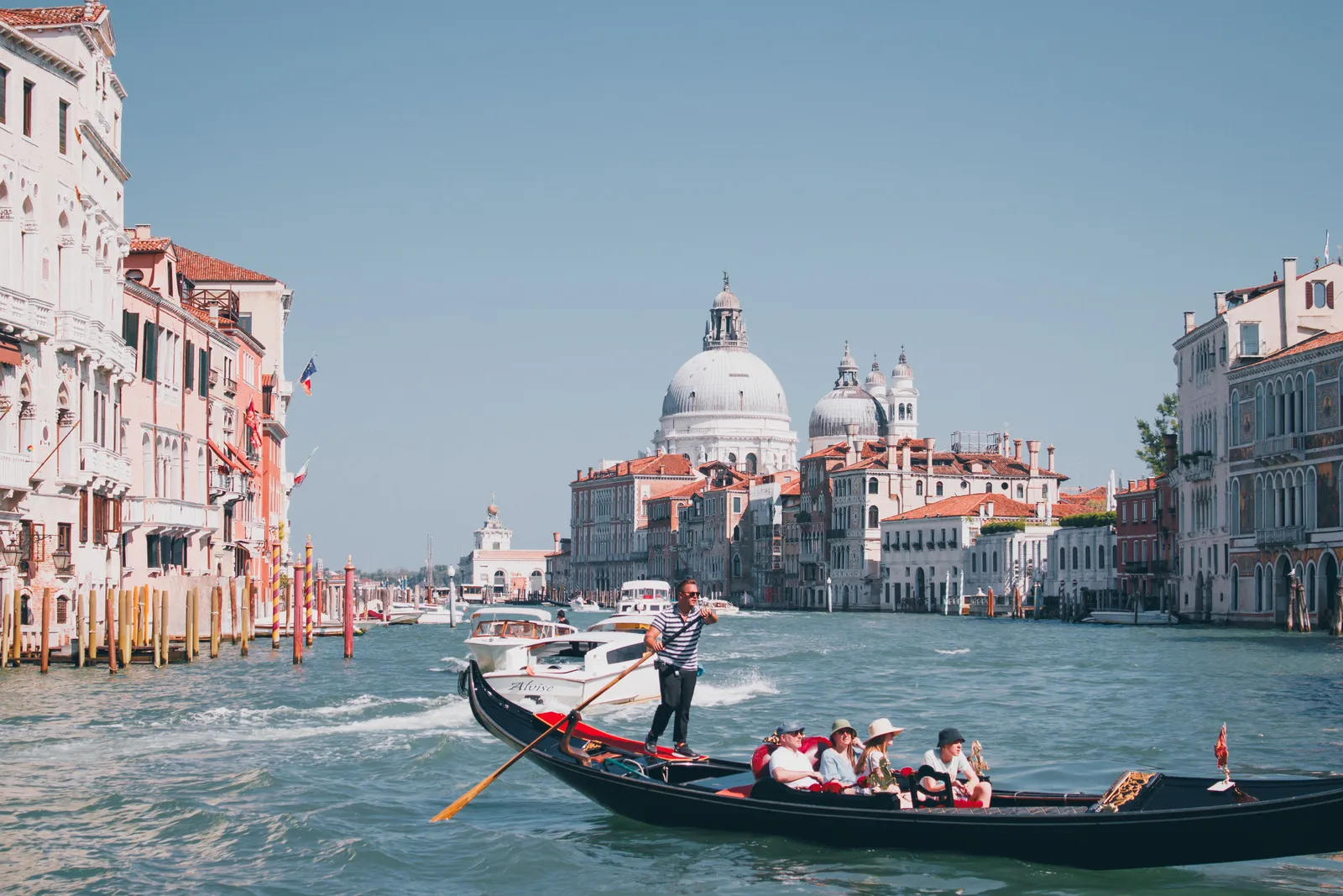 A gondola passing along a canal between old buildings in Venice, Italy