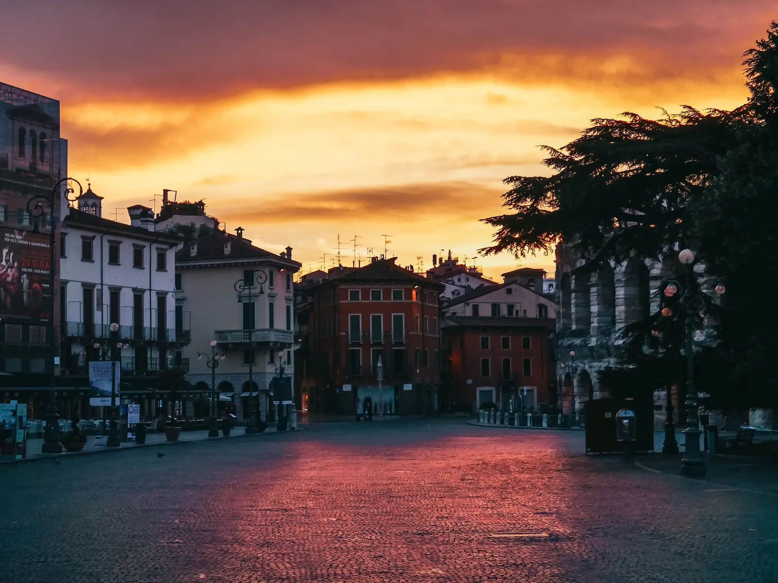 The main square of Verona at sunset with the old buildings lit, Italy