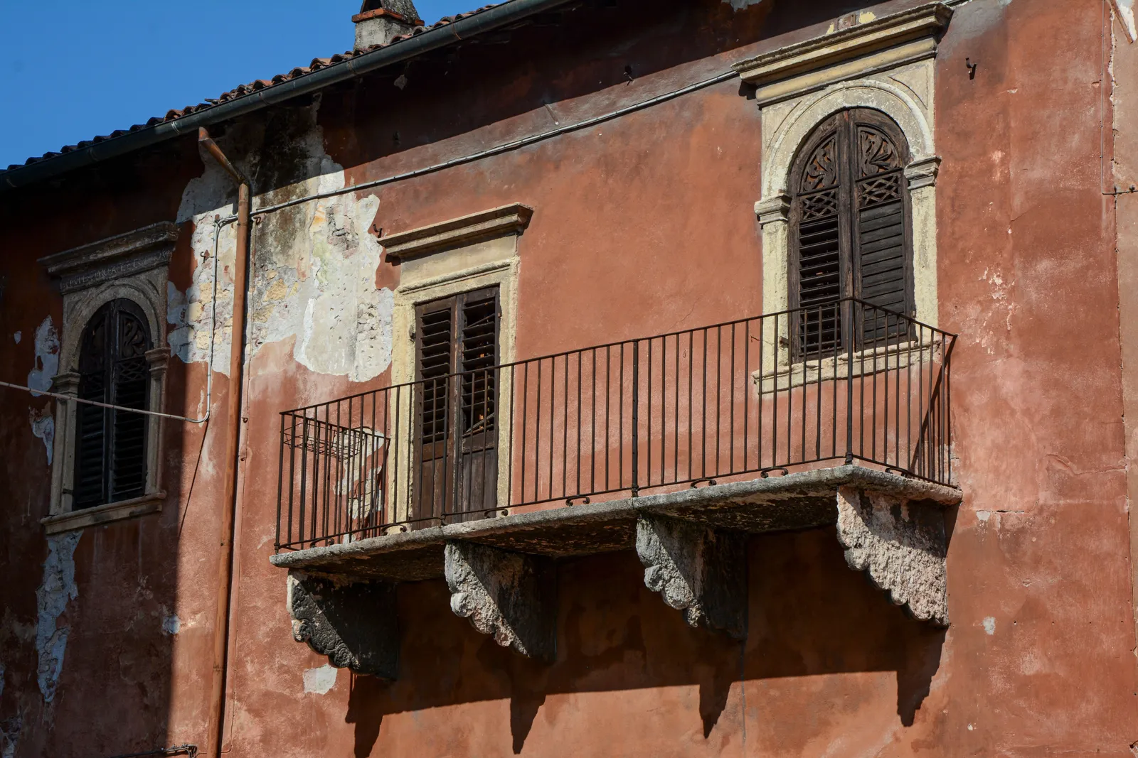 A balcony on an old stone building in the centre of Verona, Italy